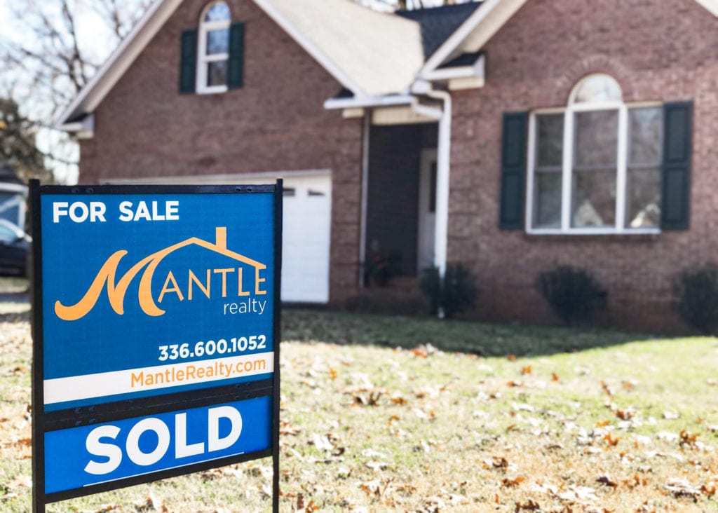 Sold Sign inf front of house