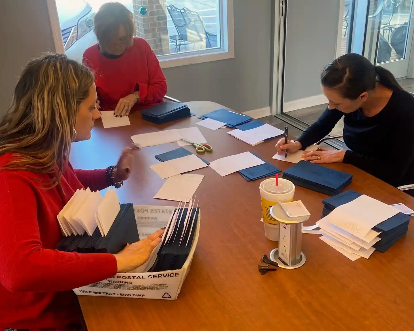 Mantle Realty agents mailing Christmas cards together at the Welcome office
