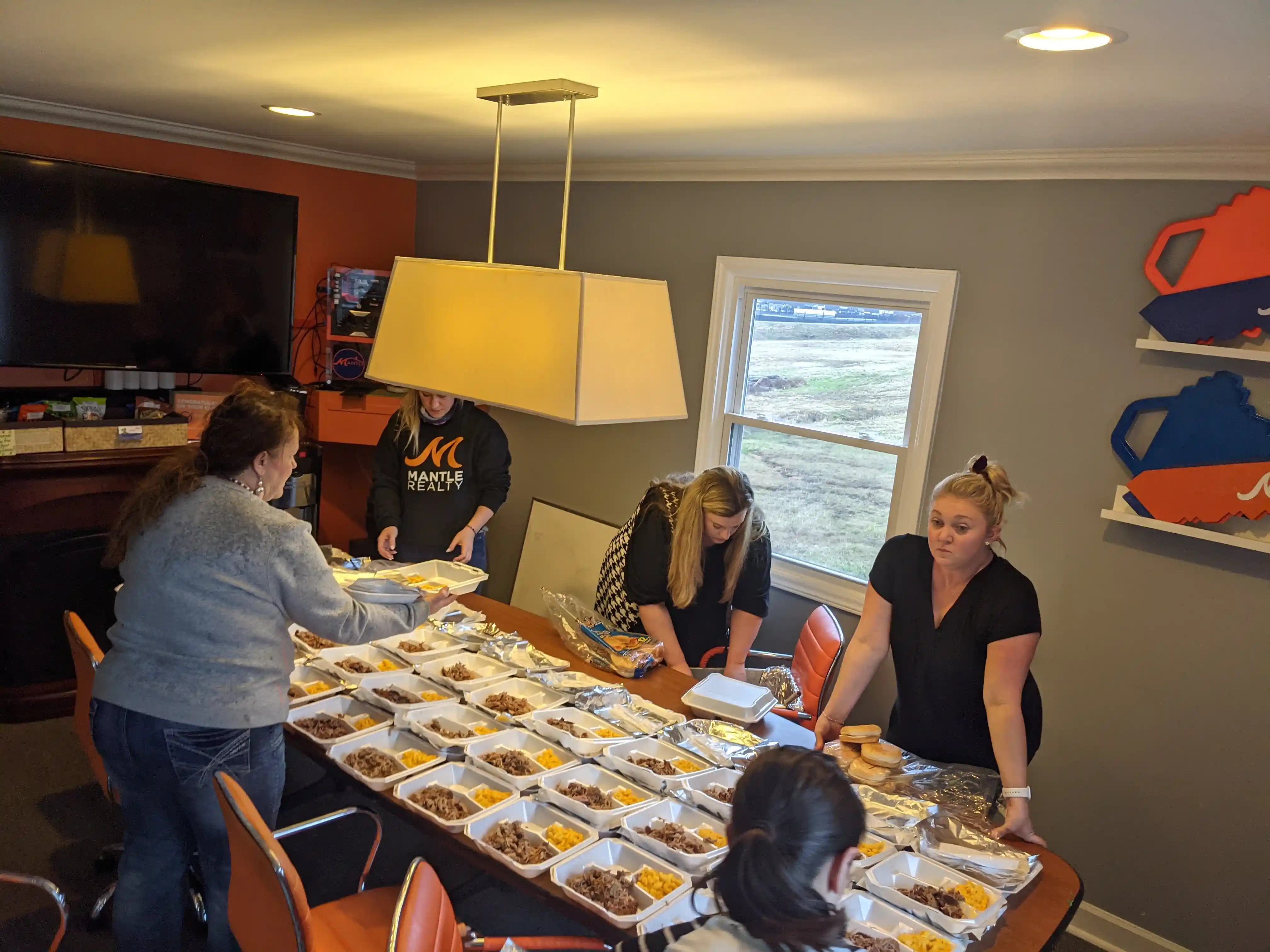 Mantle Realty agents feeding students at the Welcome office