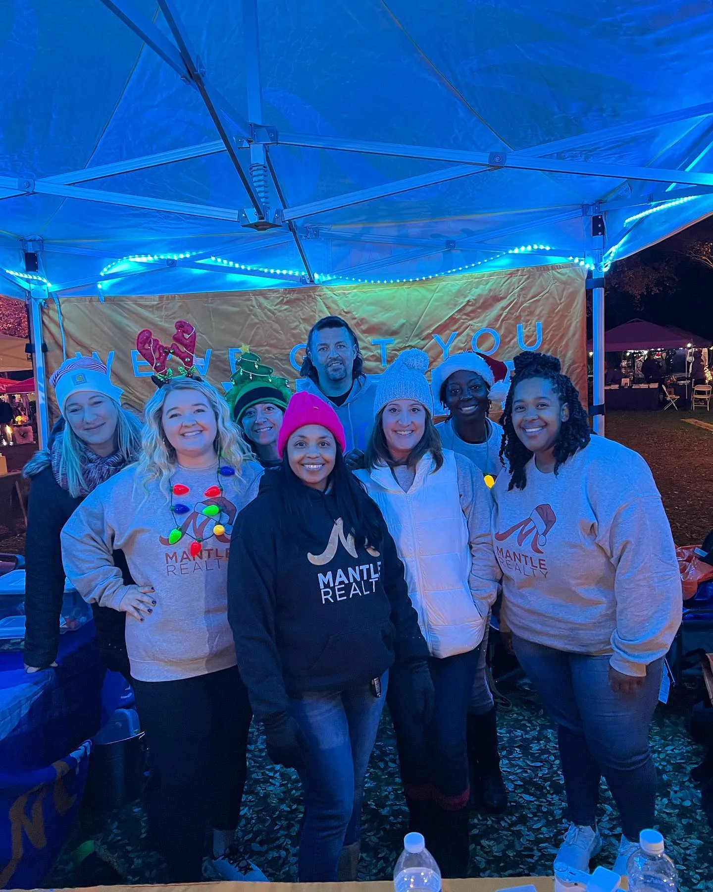 Mantle Realty agents at a community event tent in the Triad