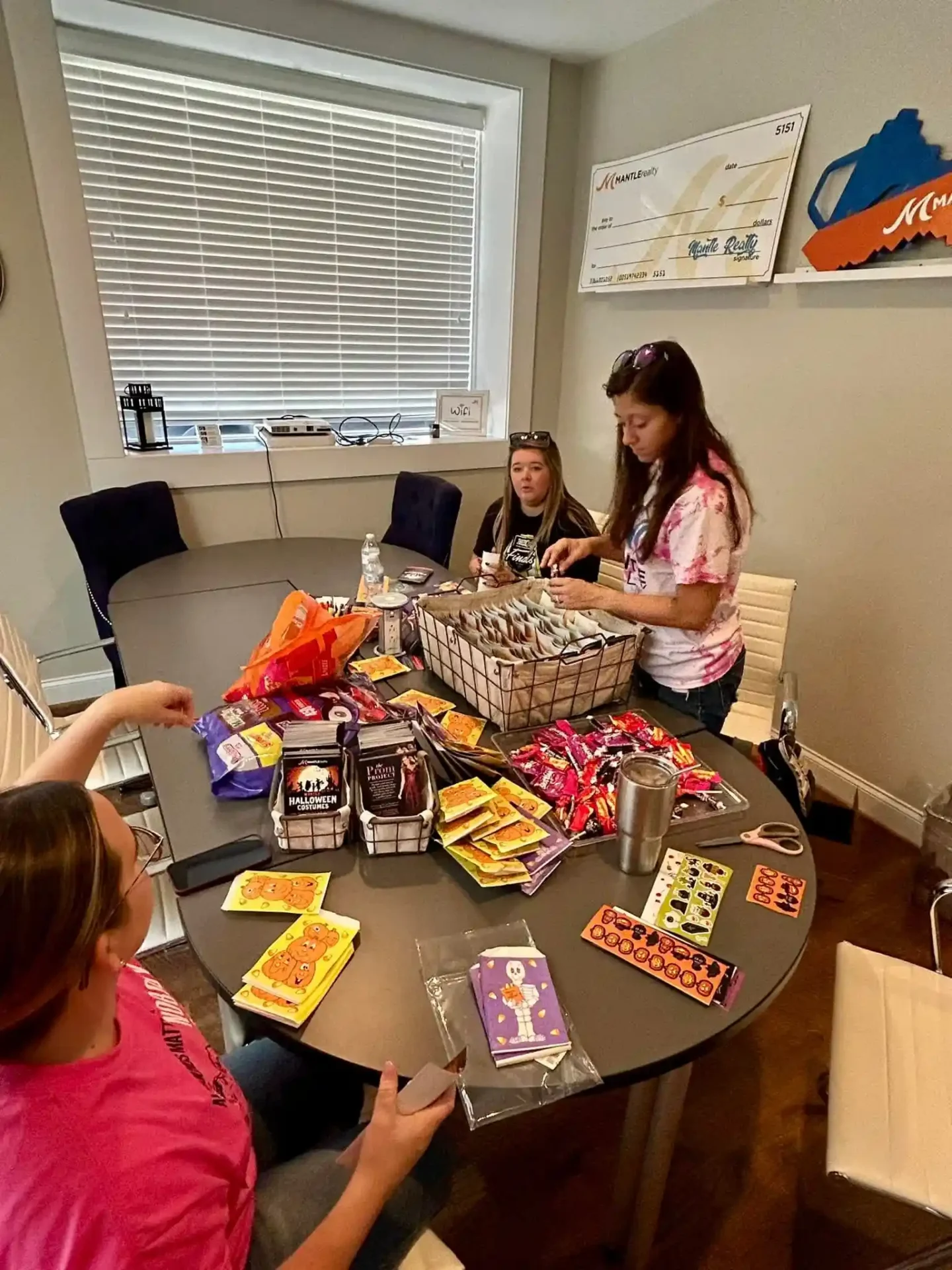Mantle Realty agents packing Halloween bags at the Kernersville office