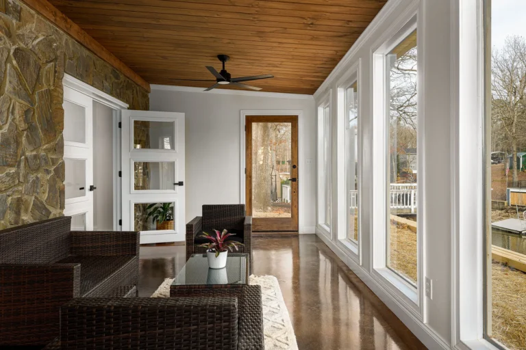 Lakefront style sunroom with stone accent wall in a Triad NC home