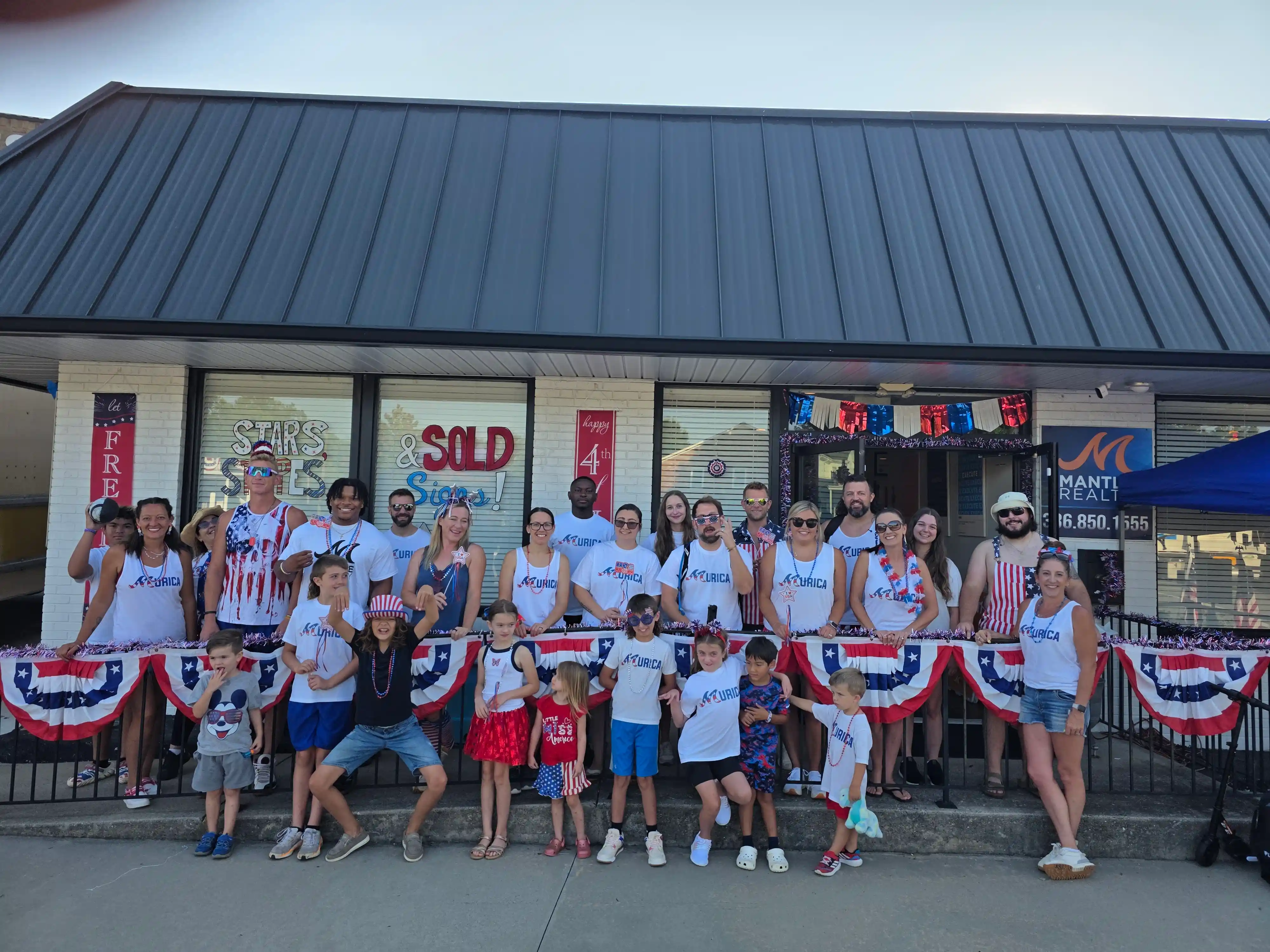Mantle Realty agents and families together before the Kernersville Fourth of July parade