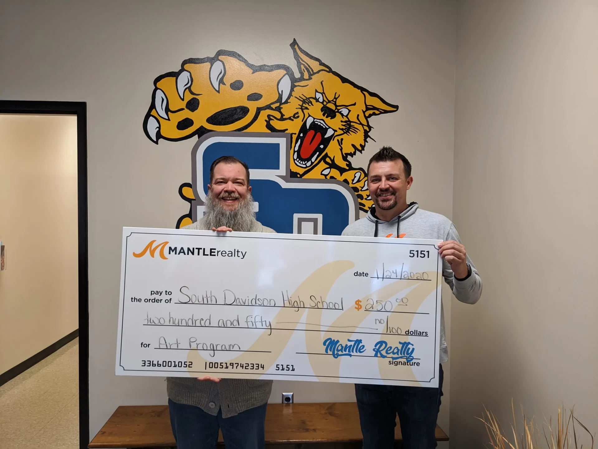 Mantle Realty giving a check to South Davidson High School