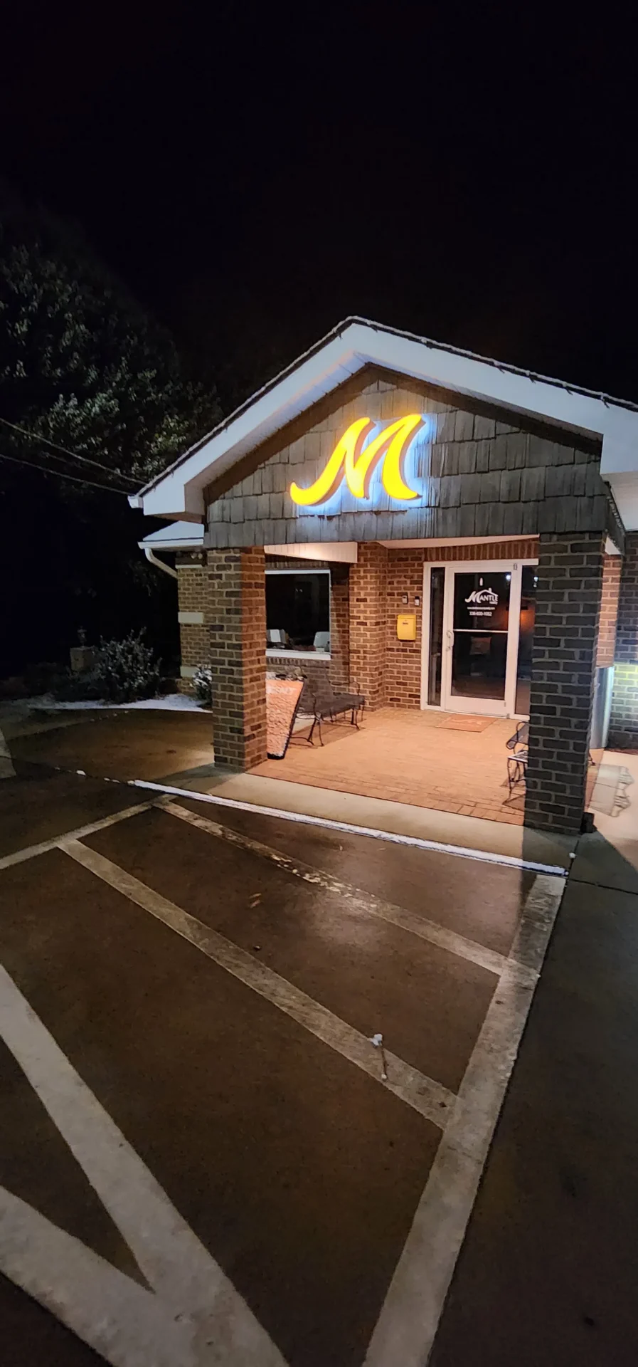 Mantle Realty Welcome office at night with the sign lit