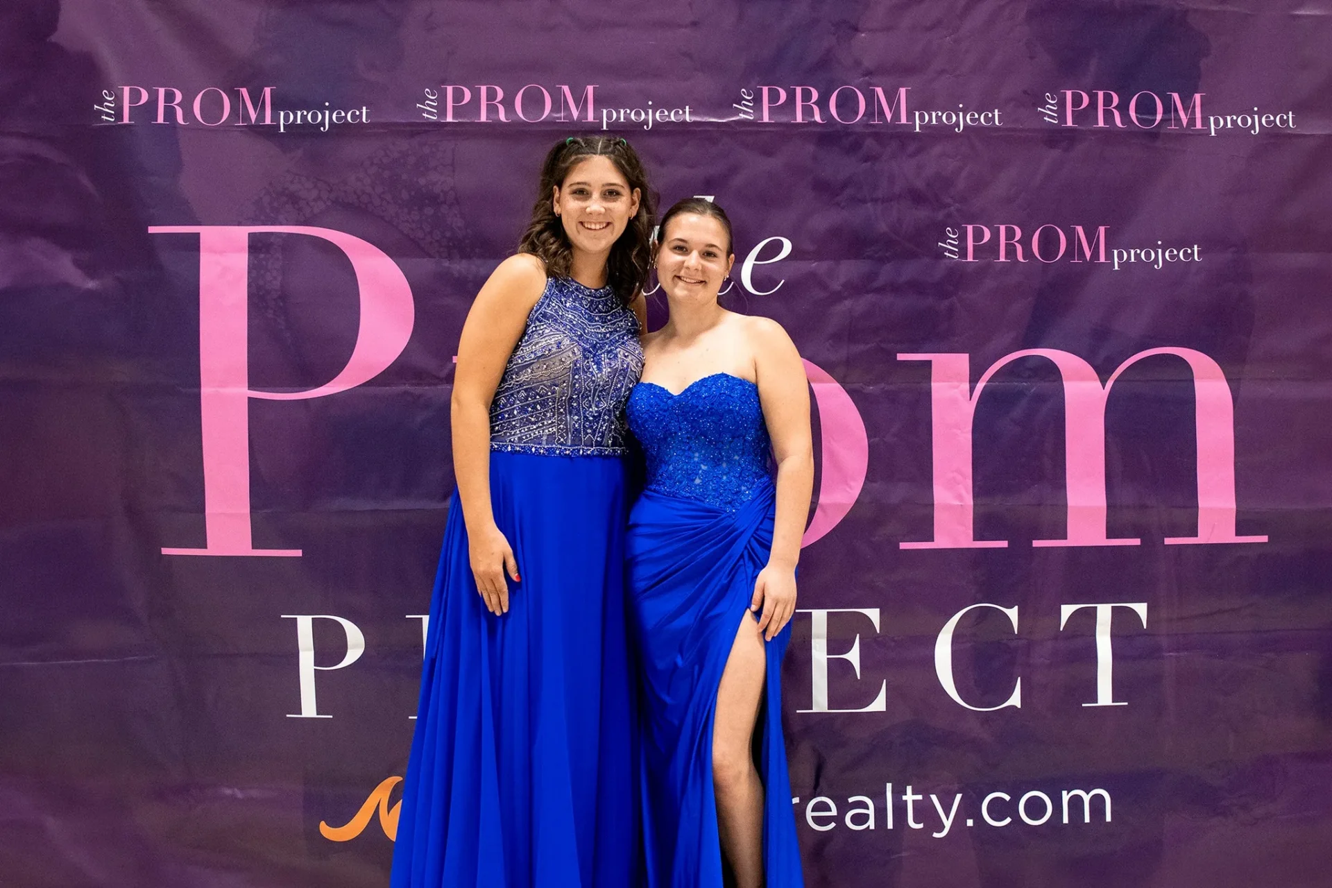 Girls trying on prom dresses during Mantle Realty Prom Project