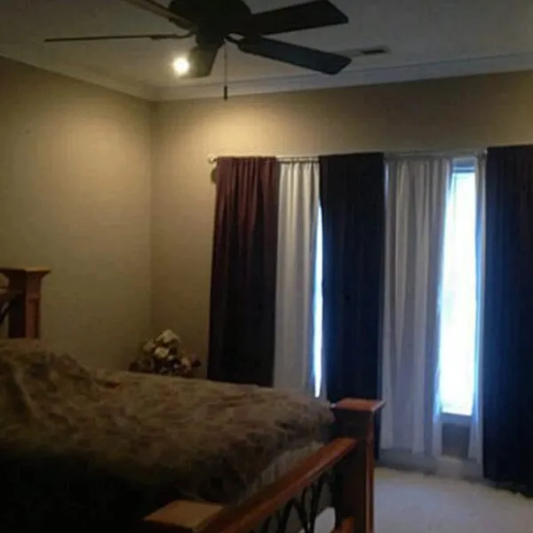 Dark bedroom listing photo in a Triad NC home with poor lighting and limited visibility